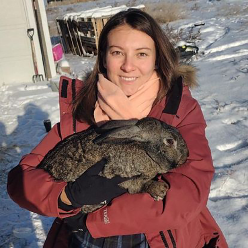 Amanada Coyle red winter coat holding rabbit